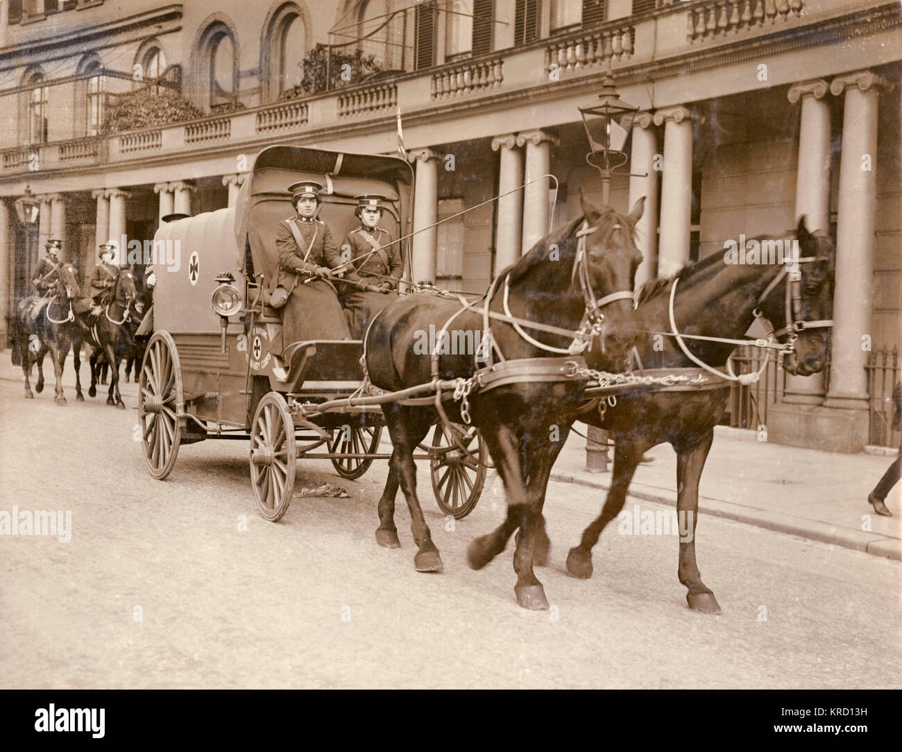 Two women of the First Aid Nursing Yeomanry (FANY) with their horse-drawn ambulance wagon.  Other members follow behind on horseback.  The FANY was created in 1907 as a first aid link between front-line fighting units and field hospitals.  During the First World War FANY members ran field hospitals, drove ambulances and set up soup kitchens and troop canteens, often under dangerous conditions.  By the time of the Armistice in November 1918 they had been awarded many decorations for bravery, including 17 Military Medals, 1 Legion d'Honneur and 27 Croix de Guerre.  They also served during the Se Stock Photo