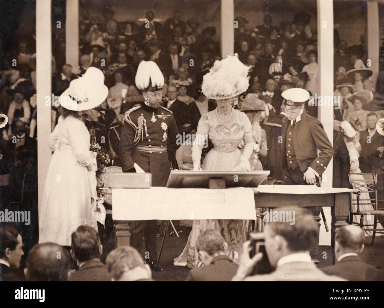 King George V and Queen Mary laying the foundation stone for the National Library at Aberystwyth, Wales.  The Prince of Wales (later Edward VIII) and Princess Mary are also present.       Date: 1911 Stock Photo