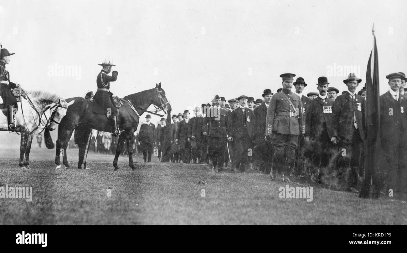 King George V reviewing the British Army Reserve in Hyde Park, Central London.  He can be seen on horseback, saluting the men as they march past him.      Date: circa 1912 Stock Photo