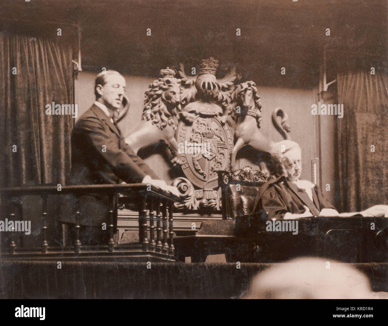 Lord Howard de Walden (Thomas Evelyn Scott-Ellis, 8th Baron Howard de Walden, 4th Baron Seaford, 1880-1946) in the witness box, giving evidence in the Lord Chief Justice's Court regarding his libel suit against Mr John Lewis of Oxford Street.  De Walden was the ground landlord of the John Lewis store, and the dispute was over his refusal to grant a lease to extend the store, as a result of which Lewis put up some mildly defamatory posters.  De Walden was eventually granted a farthing in damages.      Date: circa 1909 Stock Photo