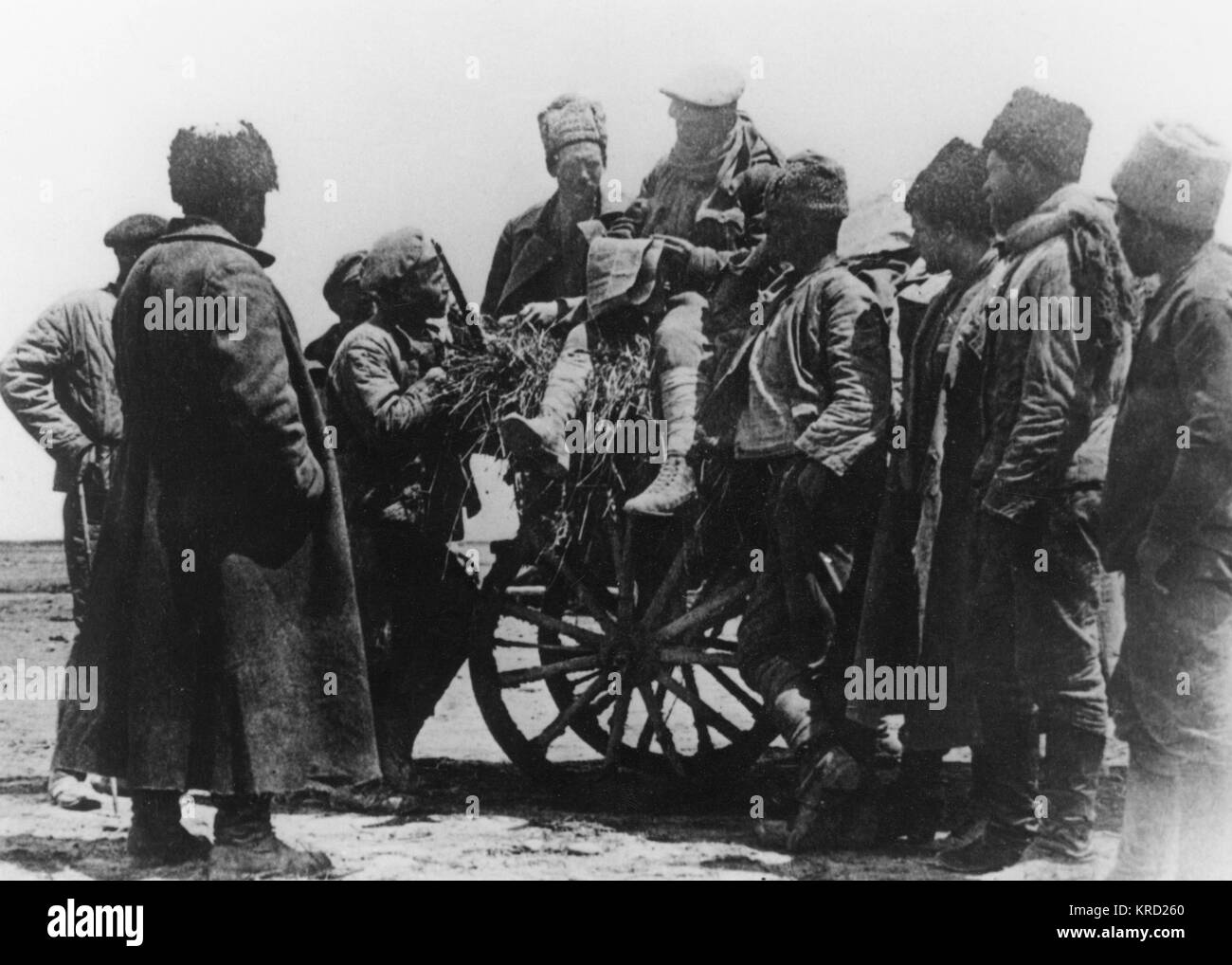 A group of Red Army soldiers, some sitting on a wooden cart, crowd