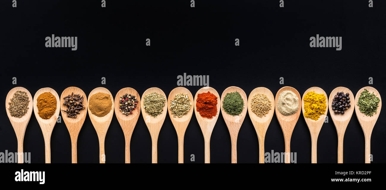 Various spices in wooden spoons. Stock Photo
