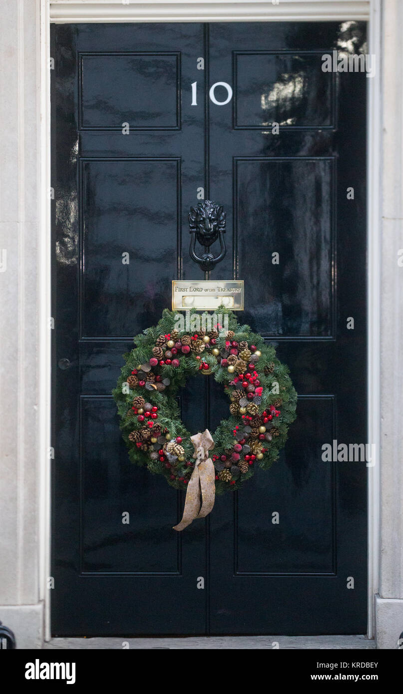 The festive door of number 10 Downing Street with a Christmas wreath on it Stock Photo