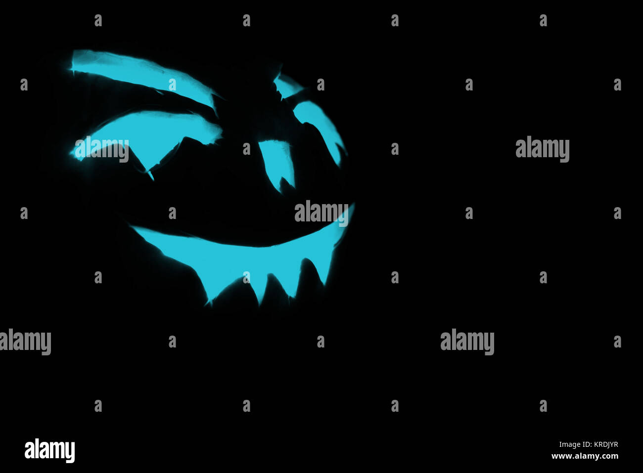 blue carved face of pumpkin glowing on Halloween black background Stock ...