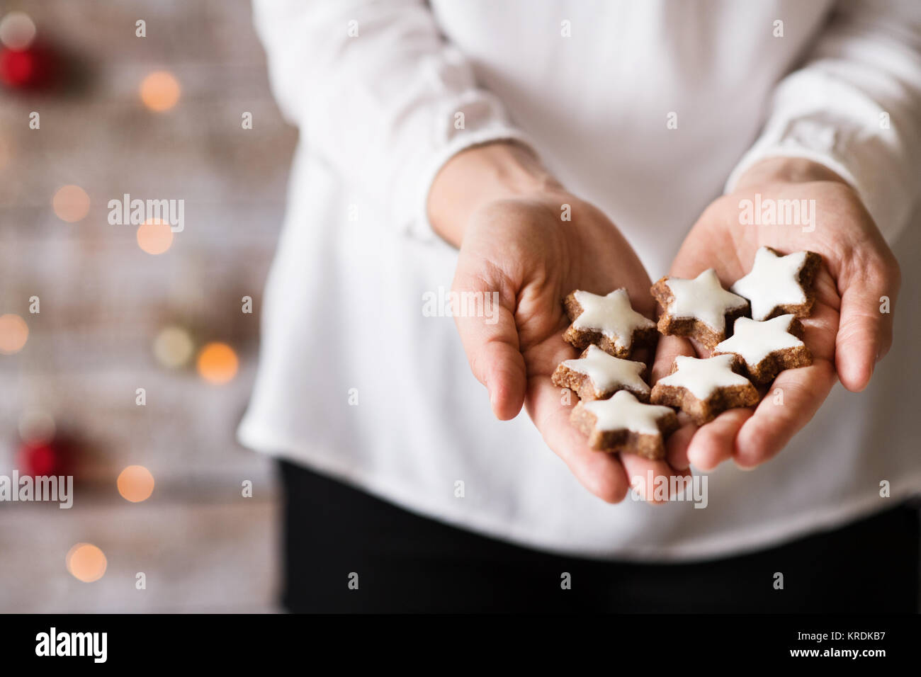 young-woman-holding-star-shaped-christmas-cookies-stock-photo-alamy