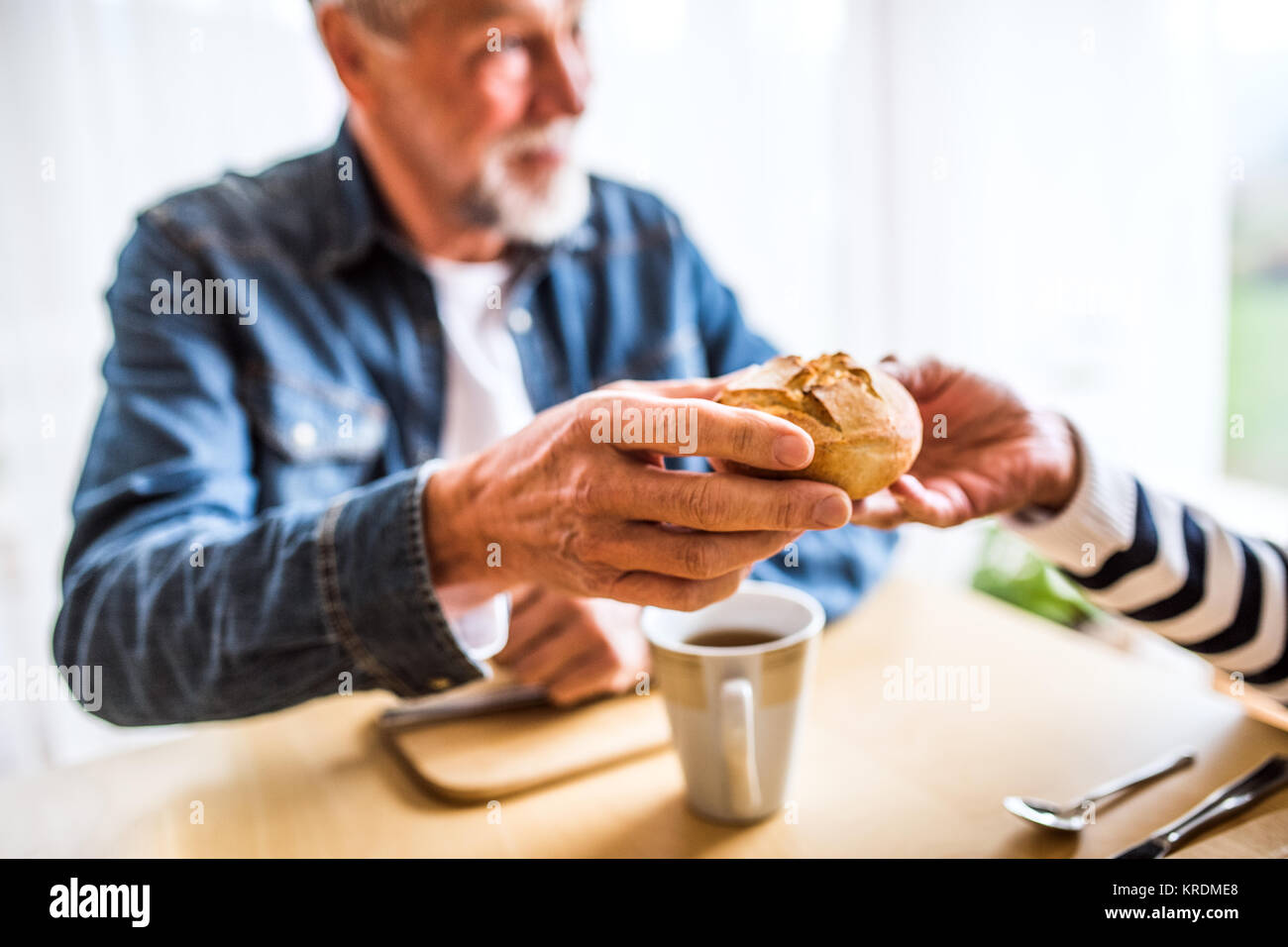 Senior couple eating breakfast at home. Stock Photo