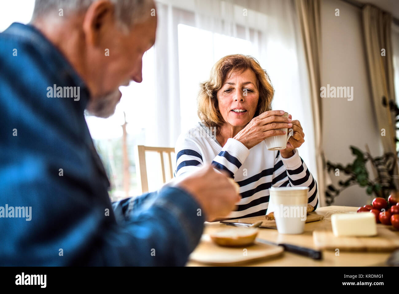 Senior couple eating breakfast at home. Stock Photo