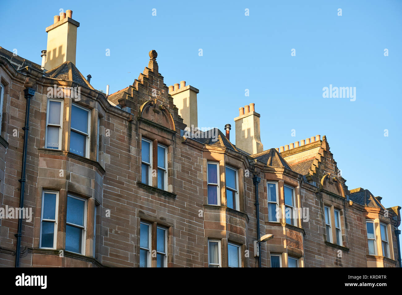 Beige sandstone tenement building typical to Scotland. Stock Photo