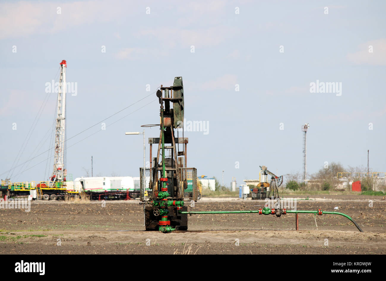 Pump jack and oil drilling rig on oilfield Stock Photo Alamy
