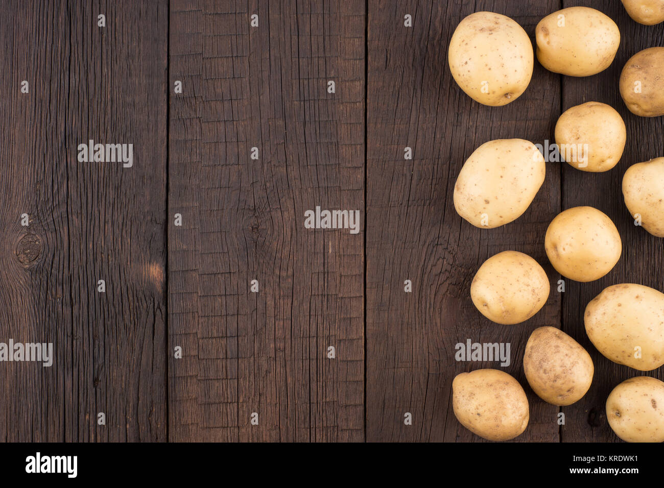 Potatoes on rustic wooden background Stock Photo - Alamy