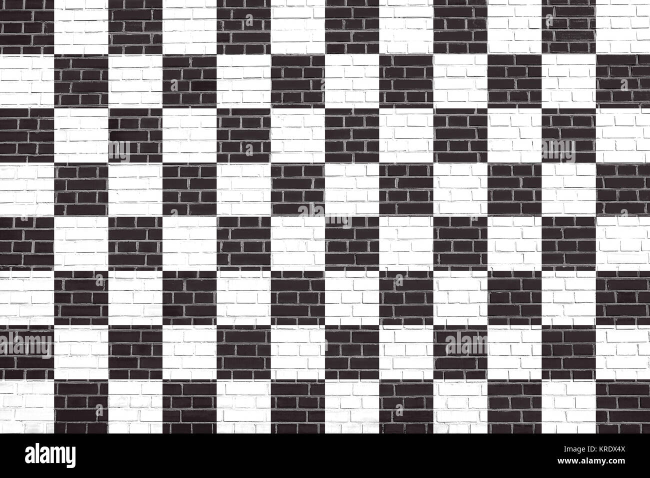 Checkered racing flag on brick wall texture Stock Photo - Alamy