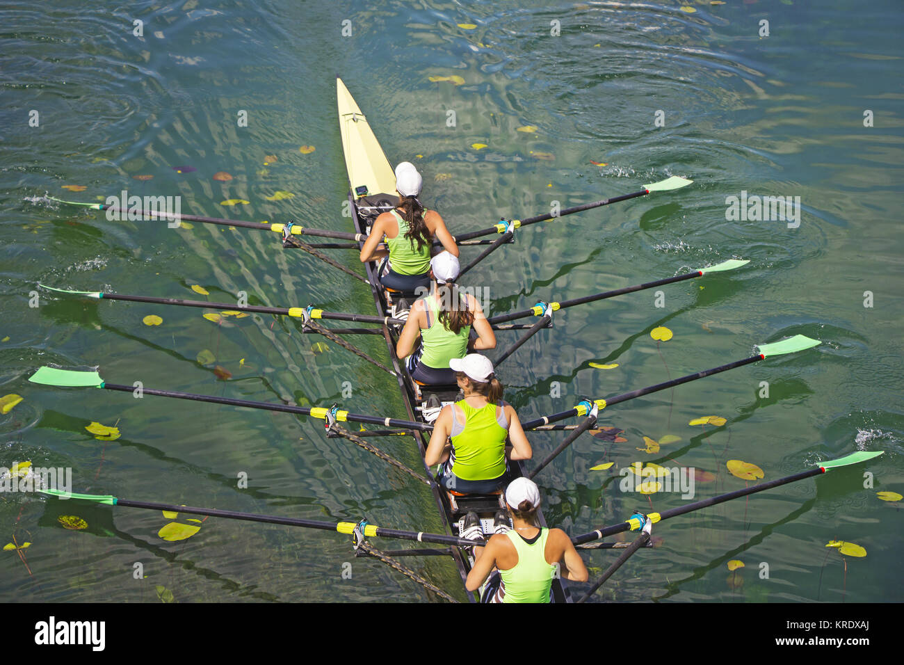 Team of rowing Four-oar women in boat Stock Photo