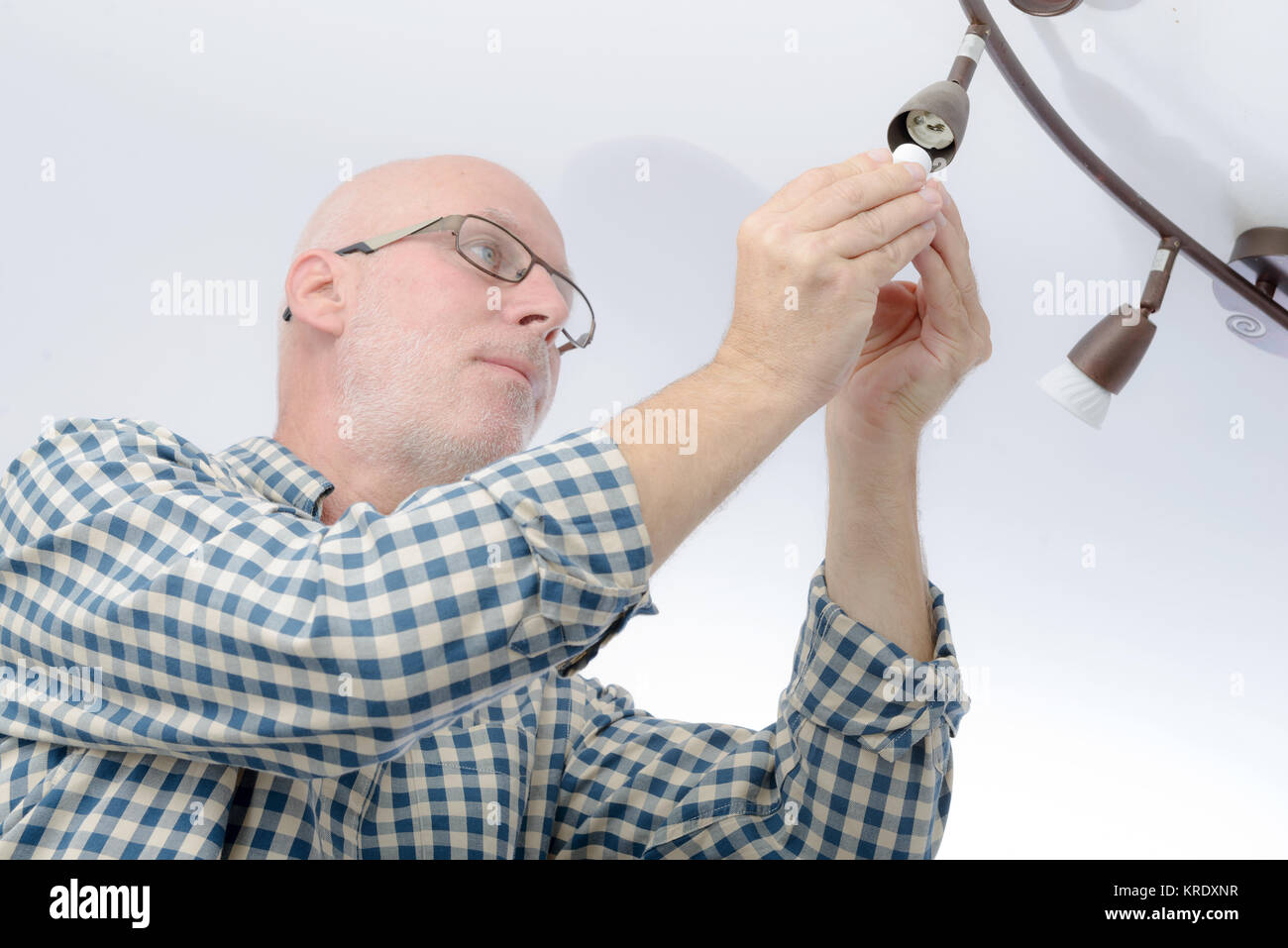 Man replacing the light bulb at home Stock Photo Alamy