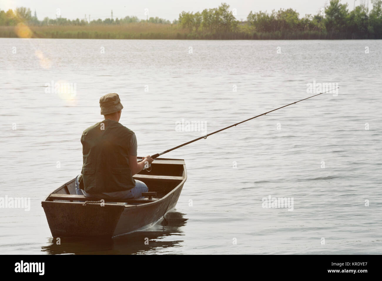 fisherman fishing-man catching fish in boat Stock Photo - Alamy