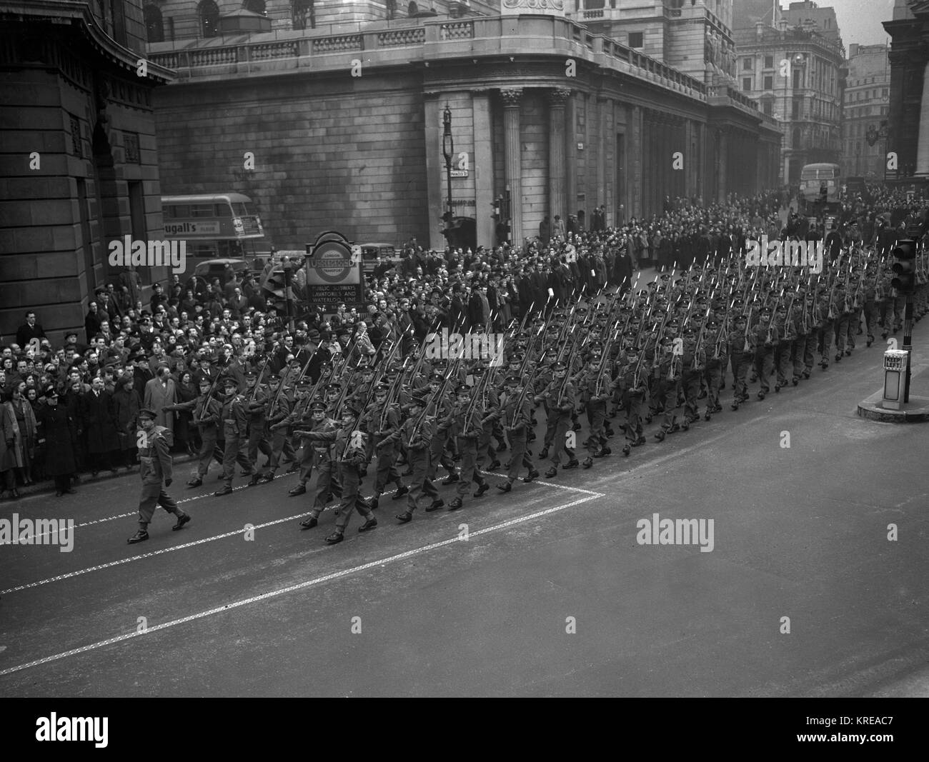Crowds watch the 2nd Battalion Grenadier Guards march past the Mansion House after arriving from Liverpool Street Station on their return from Germany. The Battalion are relieved by the 2nd battalion Coldstream Guards. Stock Photo