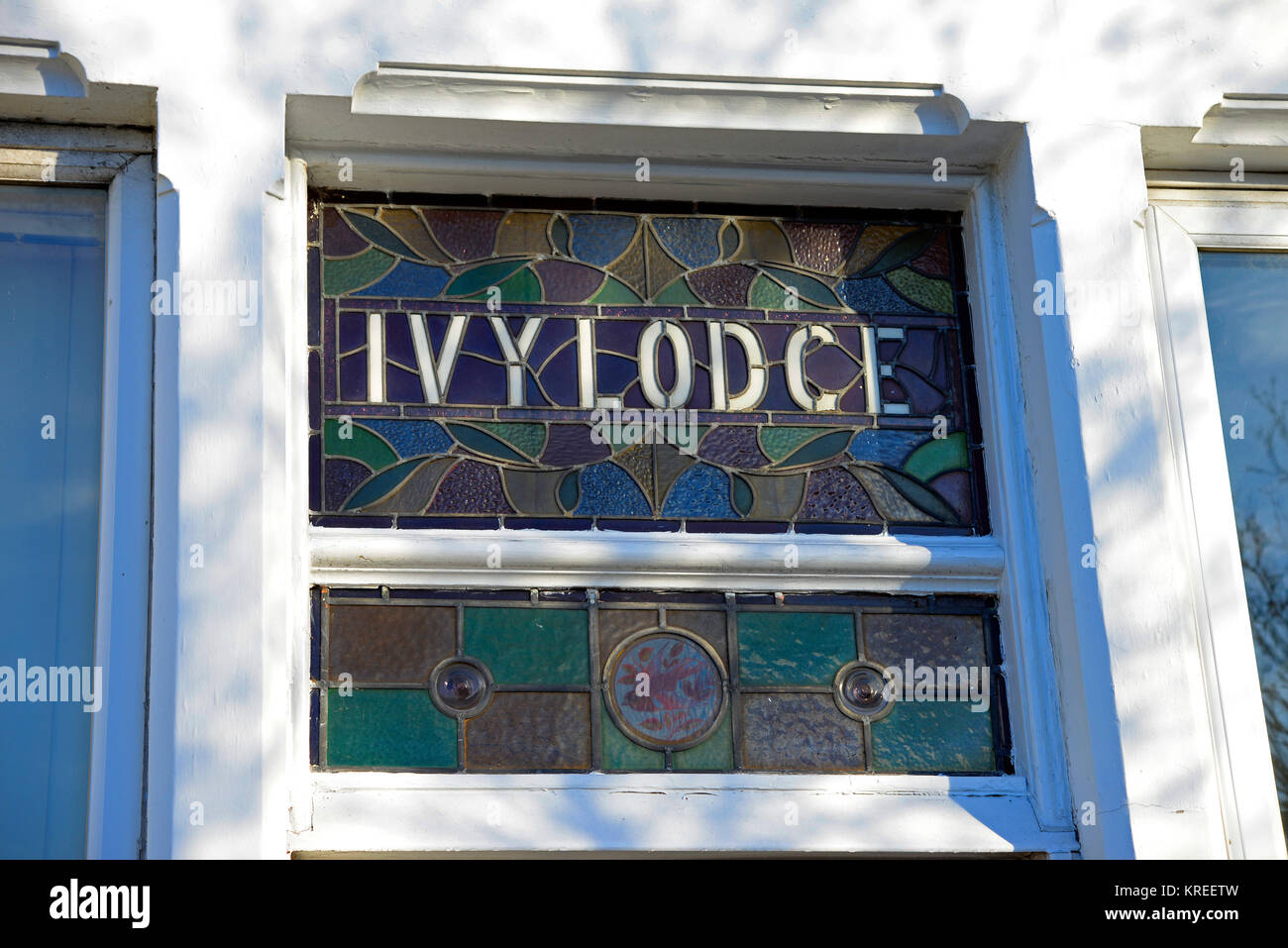Ivy Lodge leaded glass house name in window. Coloured colored glass. Vintage house entrance hall window. Westcliff on Sea, Essex Stock Photo