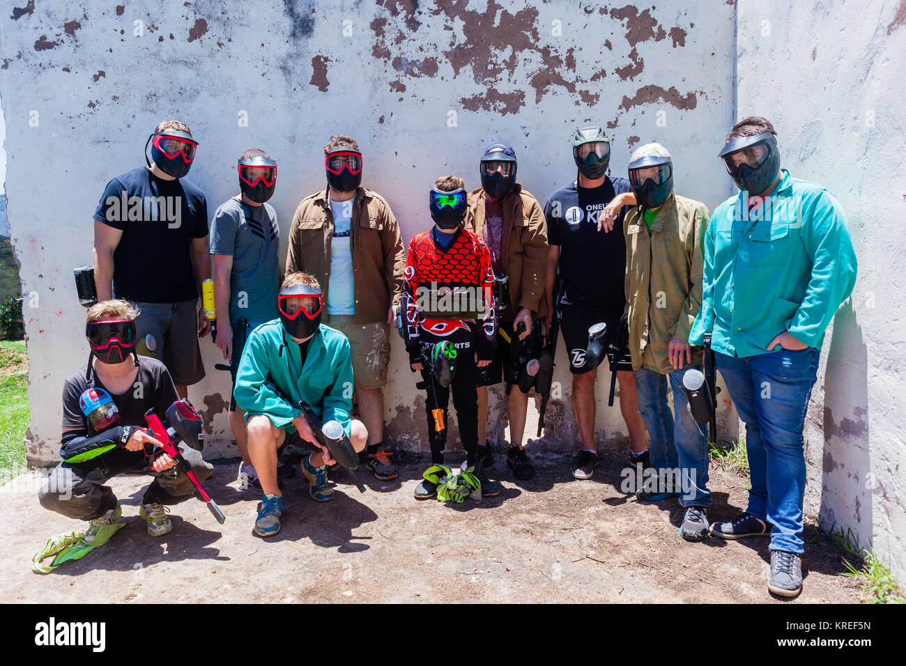 Paintball game action arena player gun in old broken house outdoors