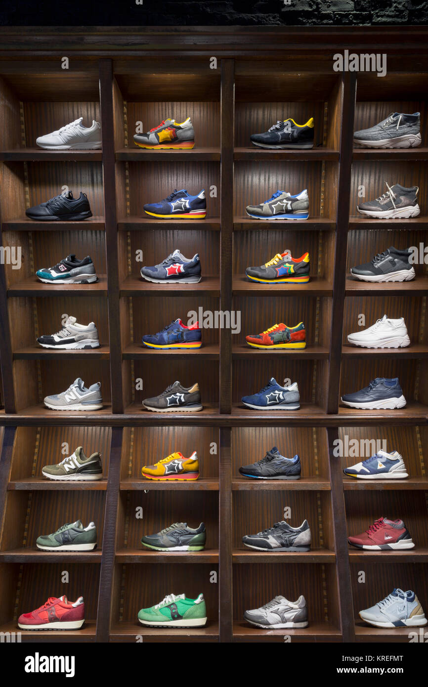 Sneakers shoes in shelves of a store, Milano, Italy Stock Photo