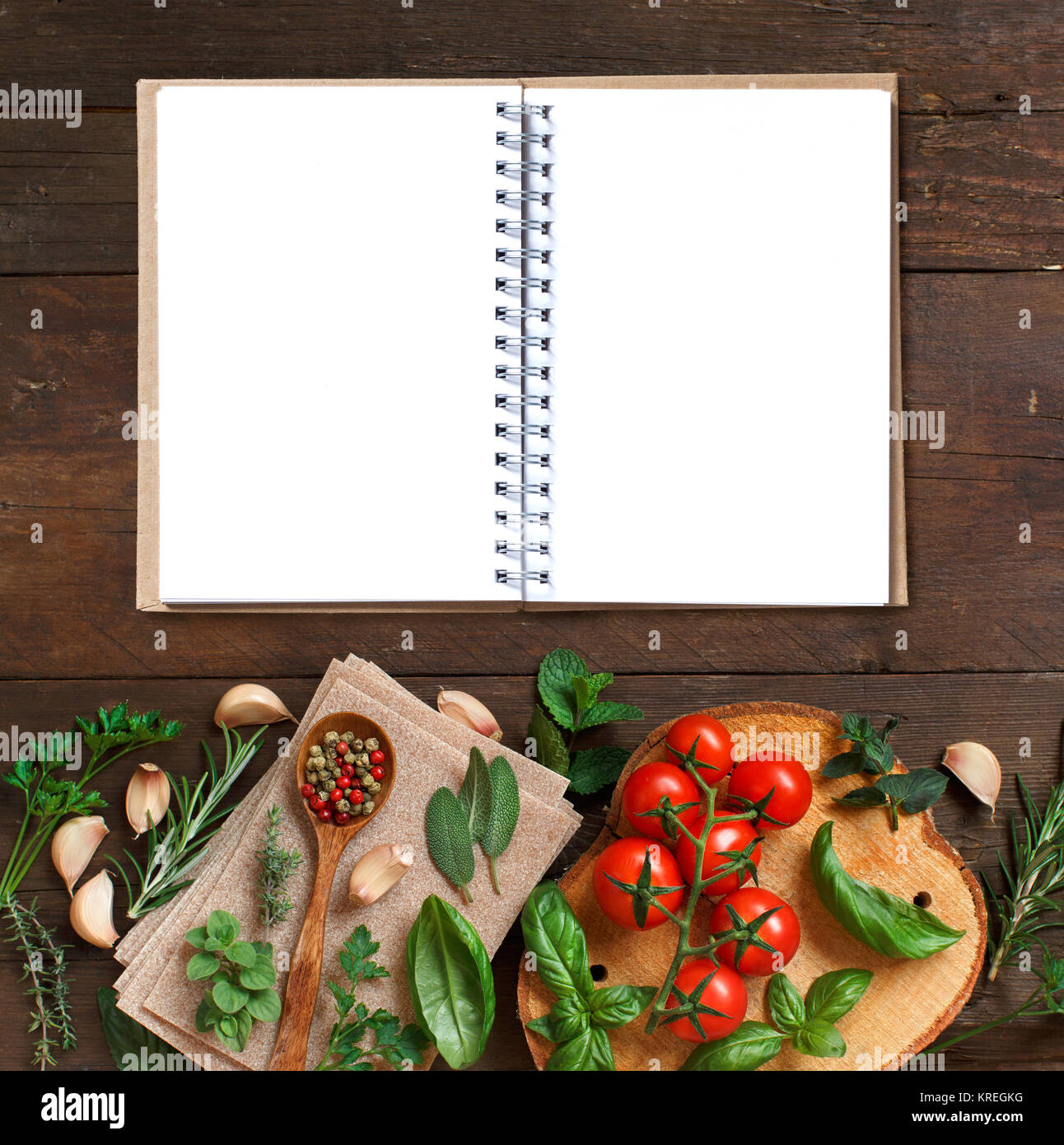 Lasagna Notebook Design Raw lasagna pasta, vegetables and herbs with notebook Stock Photo - Alamy