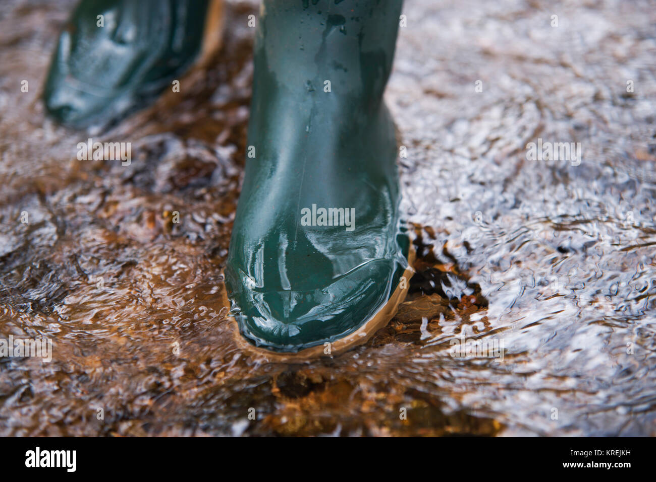 close up on rubber boots in the water Stock Photo Alamy