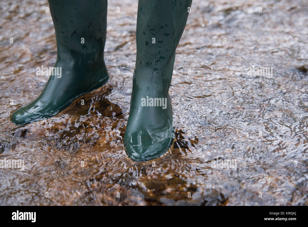 close up on rubber boots in the water Stock Photo Alamy