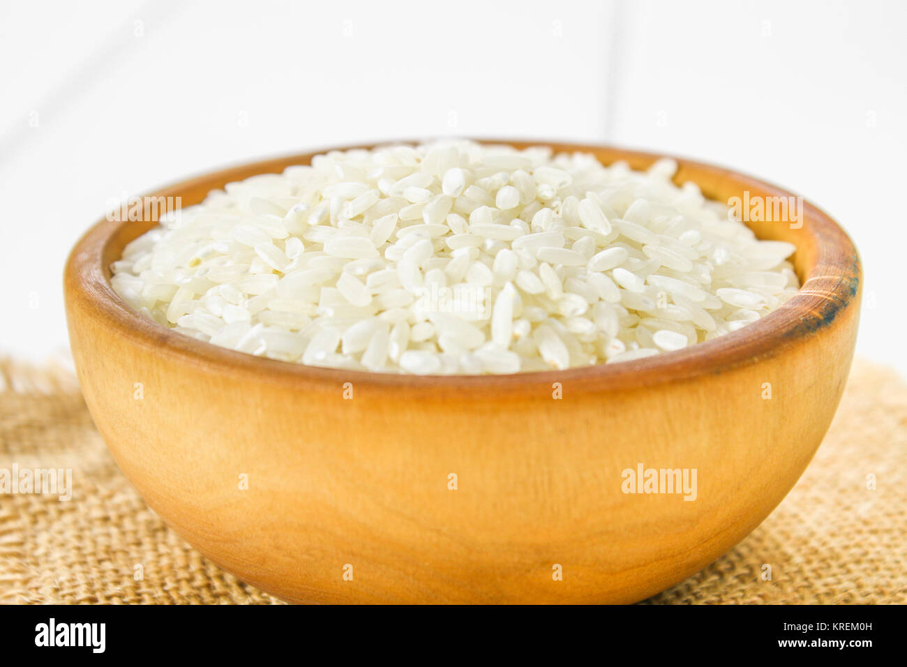 White Items Rice Grains of raw white rice on a white wooden table of boards. Ingredients ...