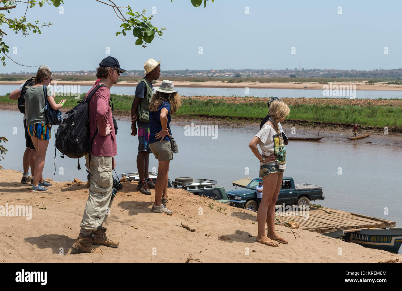 Passengers and western tourists waiting to board the ferry boat to cross Mania River. Madagascar, Africa. Stock Photo