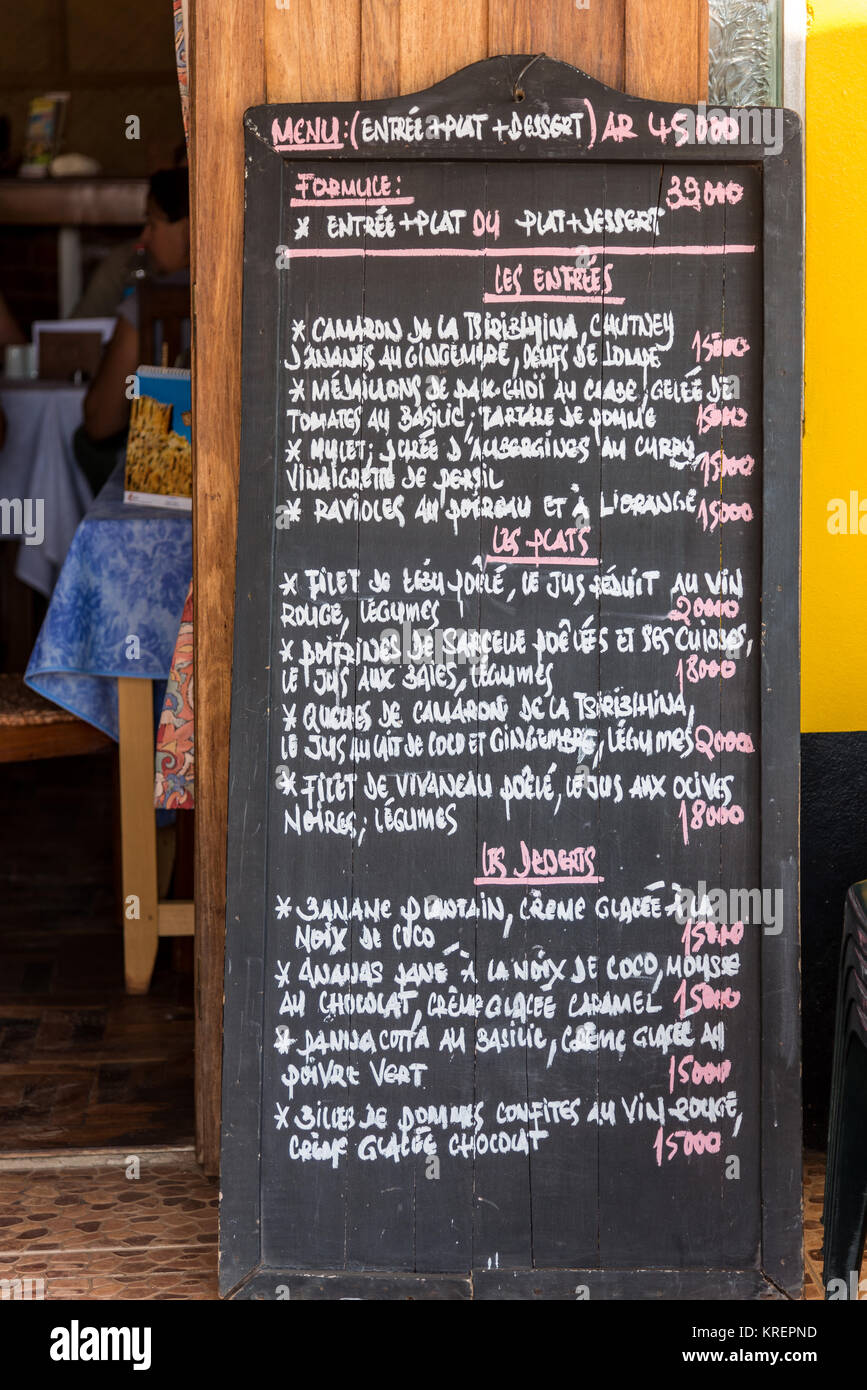 Hand-written menu on a blackboard at Mad Zebu restaurant, serves local and French food in small town Belo Tsiribihina. Madagascar, Africa. Stock Photo