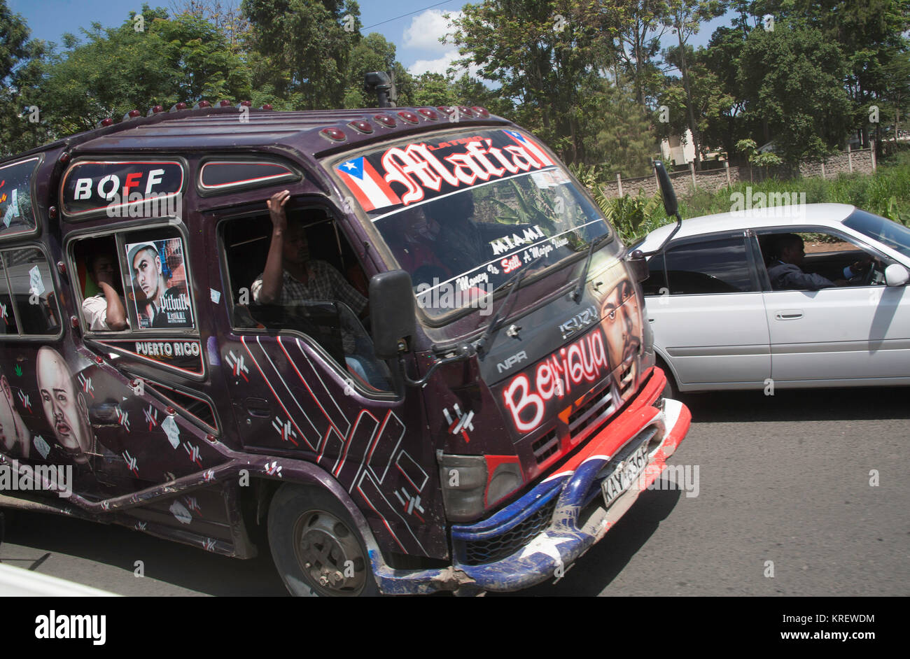 Nairobi's brightly coloured matutu minibuses drive around city centre, Nairobi, Kenya, East Africa Stock Photo