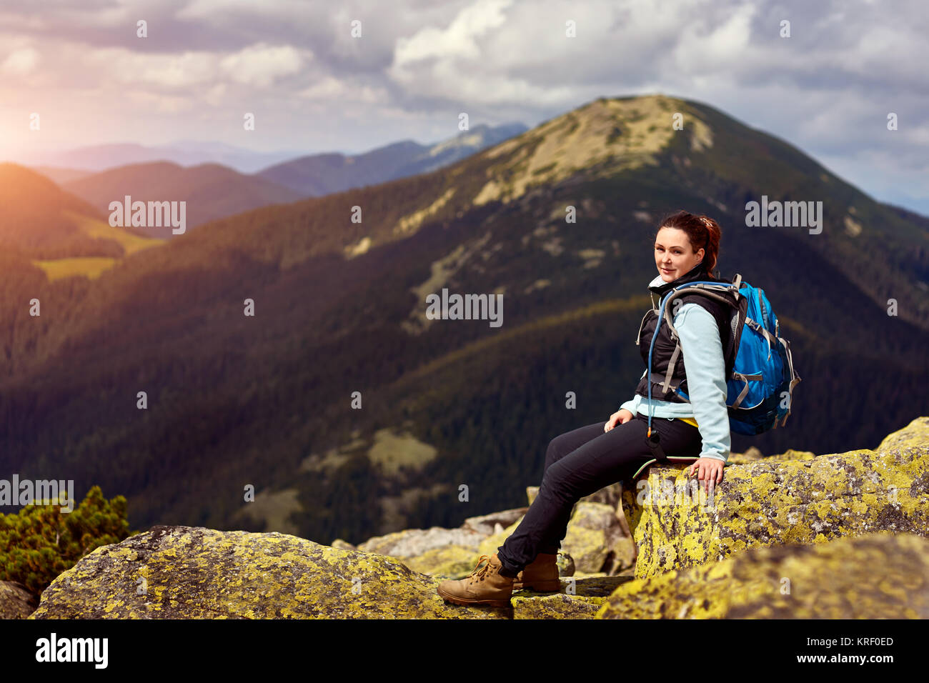 Woman hiking around mountains Stock Photo - Alamy