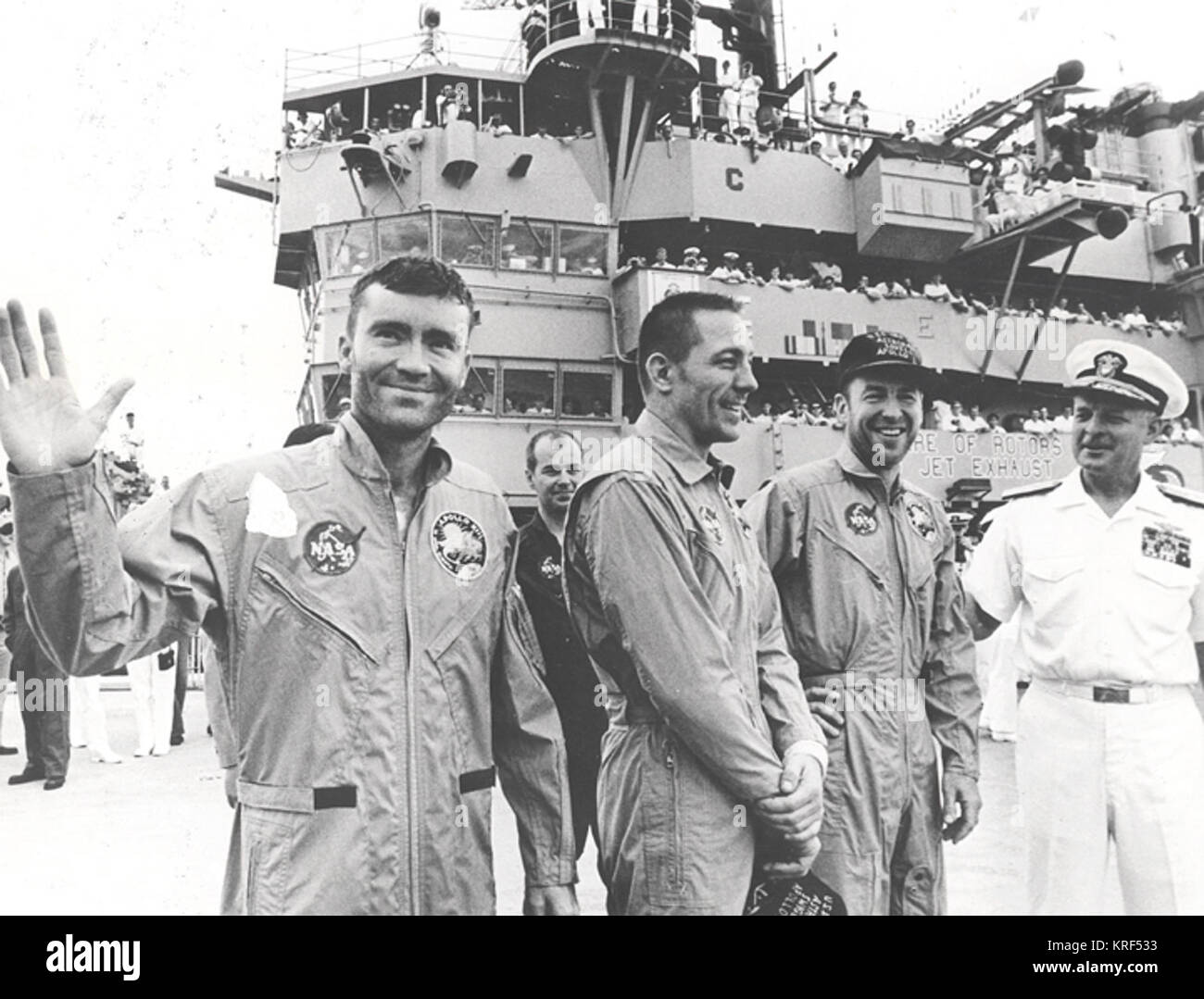REAR ADMIRAL DONALD C. DAVIS, COMMANDING OFFICER OF TASK FORCE 130, PACIFIC RECOVERY FORCES FOR THE MANNED SPACECRAFT MISSIONS, WELCOMES THE APOLLO 13 CREW ABOARD THE USS IWO JIMA, PRIME RECOVERY SHIP FOR THE MISSION.  THE CREWMEN ARE (LEFT TO RIGHT) FRED W. HAISE, JR., LUNAR MODULE PILOT, JOHN L. SWIGERT, JR., COMMAND MODULE PILOT, AND JAMES A. LOVELL, JR., MISSION COMMANDER. THE SPACECRAFT SPLASHED DOWN WITHIN SIGHT OF THE CARRIER TO SAFELY END A PERILOUS JOURNEY. Załoga Apollo 13 na pokładzie USS Iwo Jima 7008011 Stock Photo
