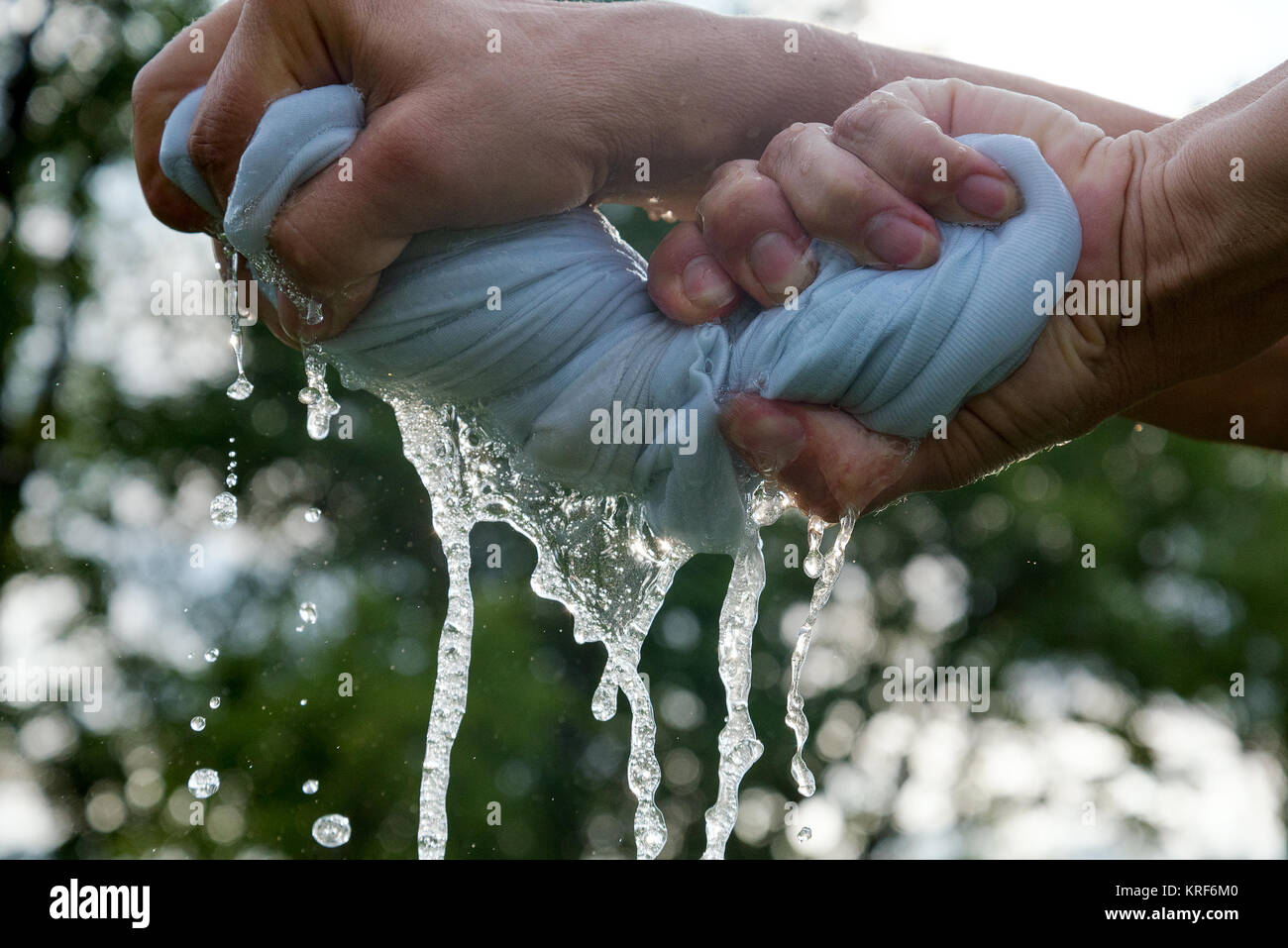 Hands squeeze wet cloth Stock Photo Alamy