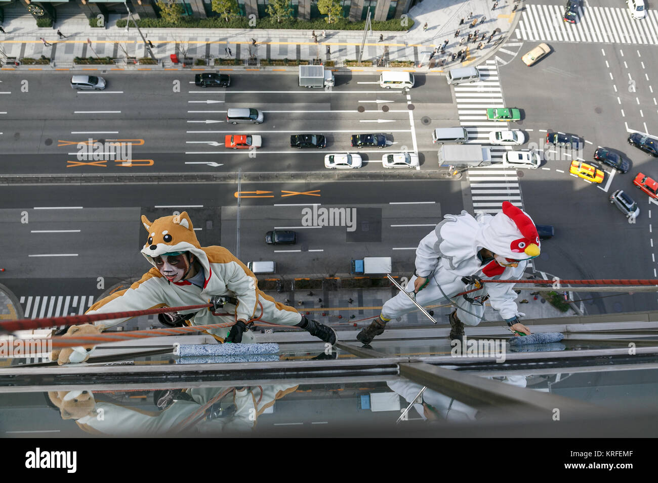 Tokyo, Japan. 20th December, 2017. Window cleaners dressed as dog and ...