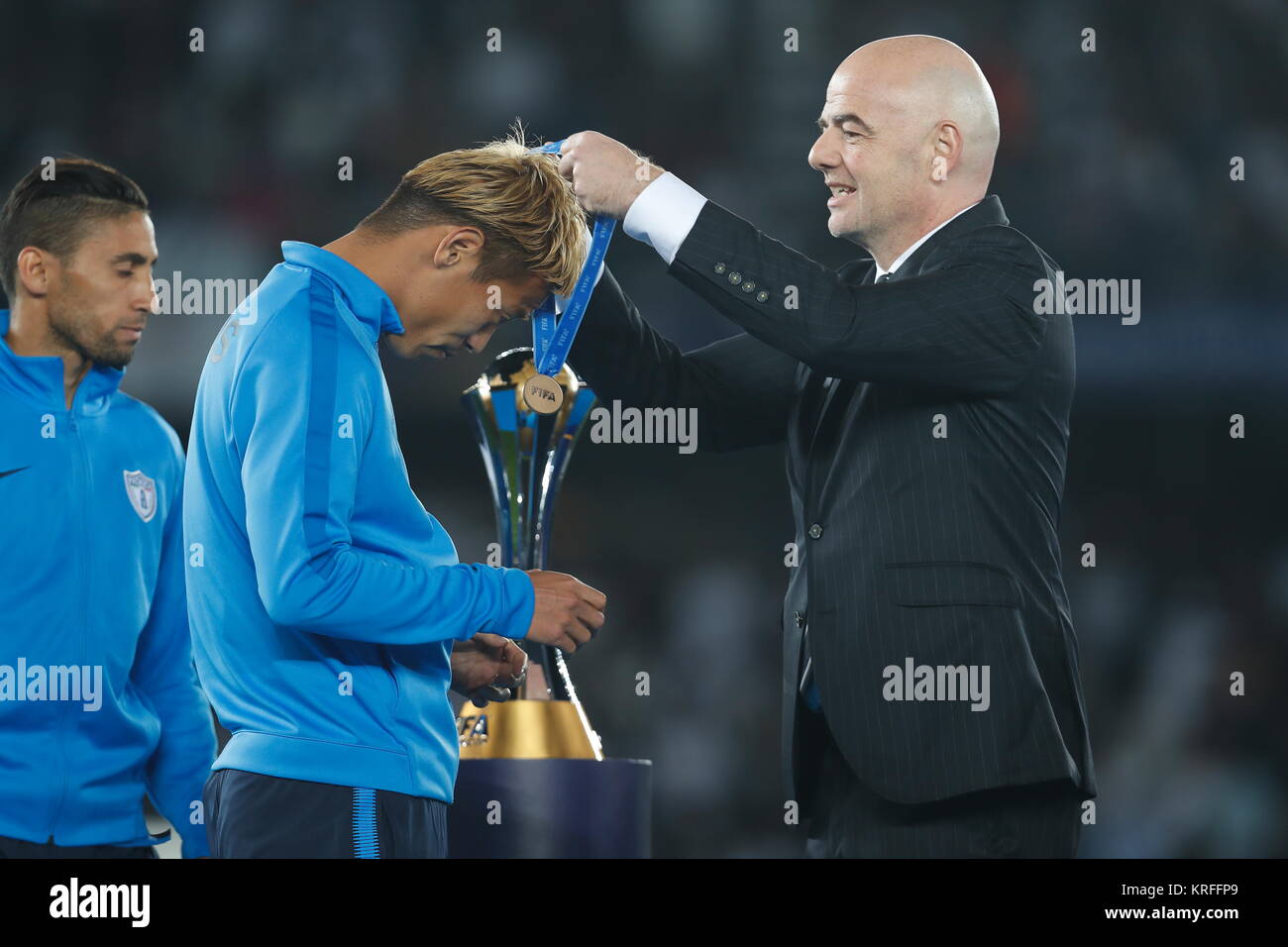 Abu Dhabi, UAE. 16th Dec, 2017. (L-R) Keisuke Honda (Pachuca), Gianni Infantino (FIFA) Football/Soccer : Honda receive 3rd place medal from Infantino during awards ceremony of FIFA Club World Cup UAE 2017 at the Zayed Sports City Stadium in Abu Dhabi, UAE . Credit: Mutsu Kawamori/AFLO/Alamy Live News Stock Photo