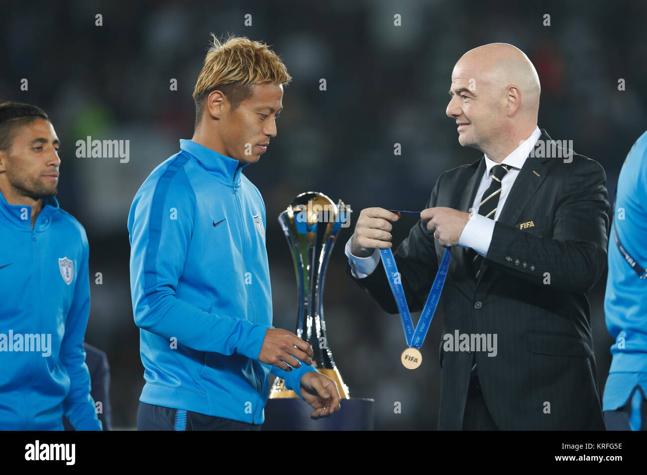 Abu Dhabi, UAE. 16th Dec, 2017. (L-R) Keisuke Honda (Pachuca), Gianni Infantino (FIFA) Football/Soccer : Honda receive 3rd place medal from Infantino during awards ceremony of FIFA Club World Cup UAE 2017 at the Zayed Sports City Stadium in Abu Dhabi, UAE . Credit: Mutsu Kawamori/AFLO/Alamy Live News Stock Photo