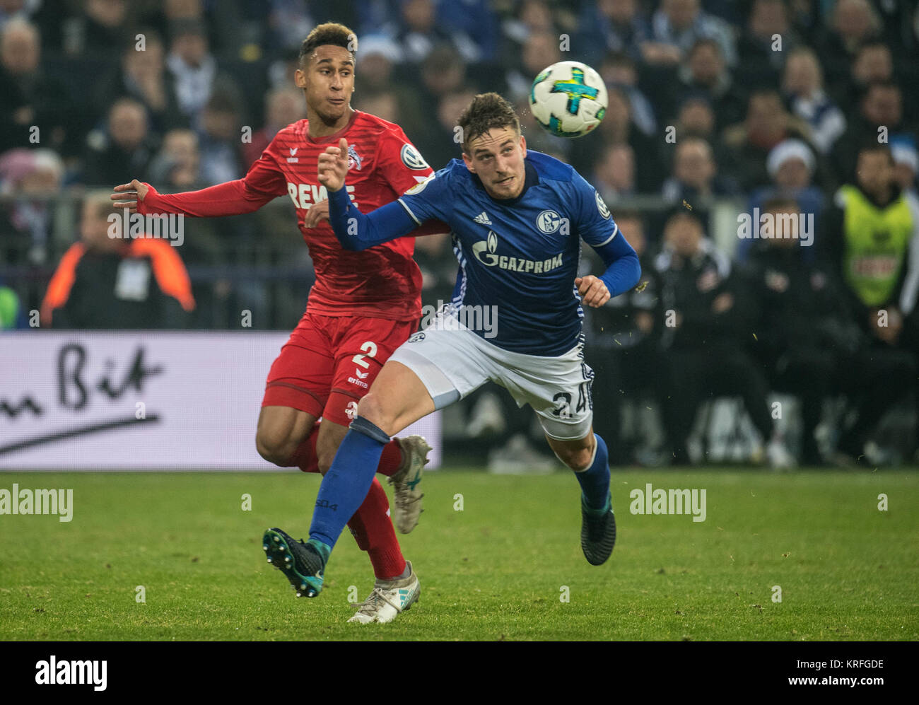 Gelsenkirchen, Germany. 19th Dec, 2017. Schalke's Bastian Oczipka (r) and Cologne's Kevin Goden in action during the German DFB Cup soccer match between FC Schalke 04 and 1. FC Cologne in the Veltins Arena in Gelsenkirchen, Germany, 19 December 2017. Credit: Bernd Thissen/dpa/Alamy Live News Stock Photo