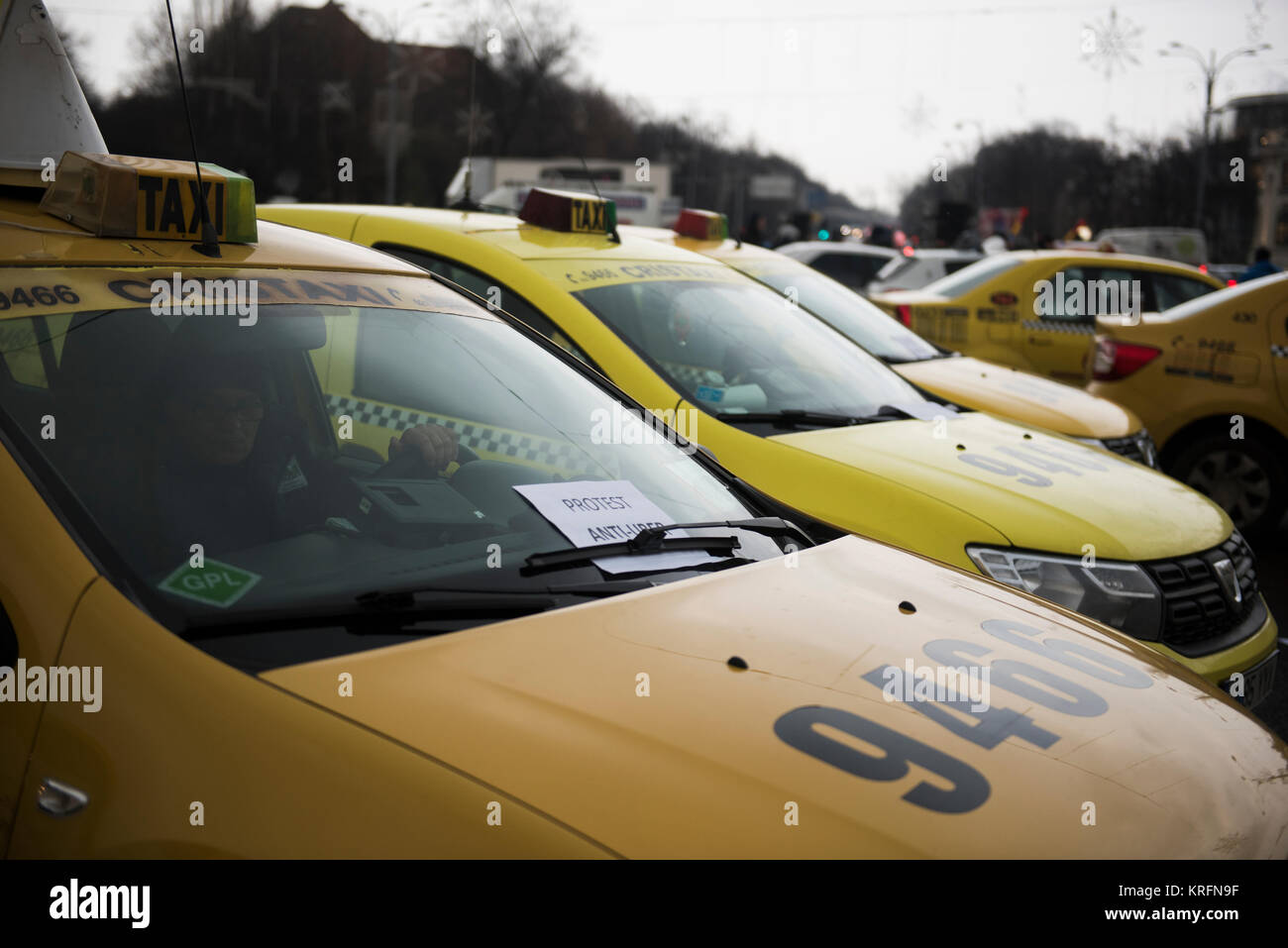 Bucharest, Romania - December 20, 2017: Romanian taxi drivers protest in front of the government headquarters against Uber and other apps that steal their clients. Stock Photo