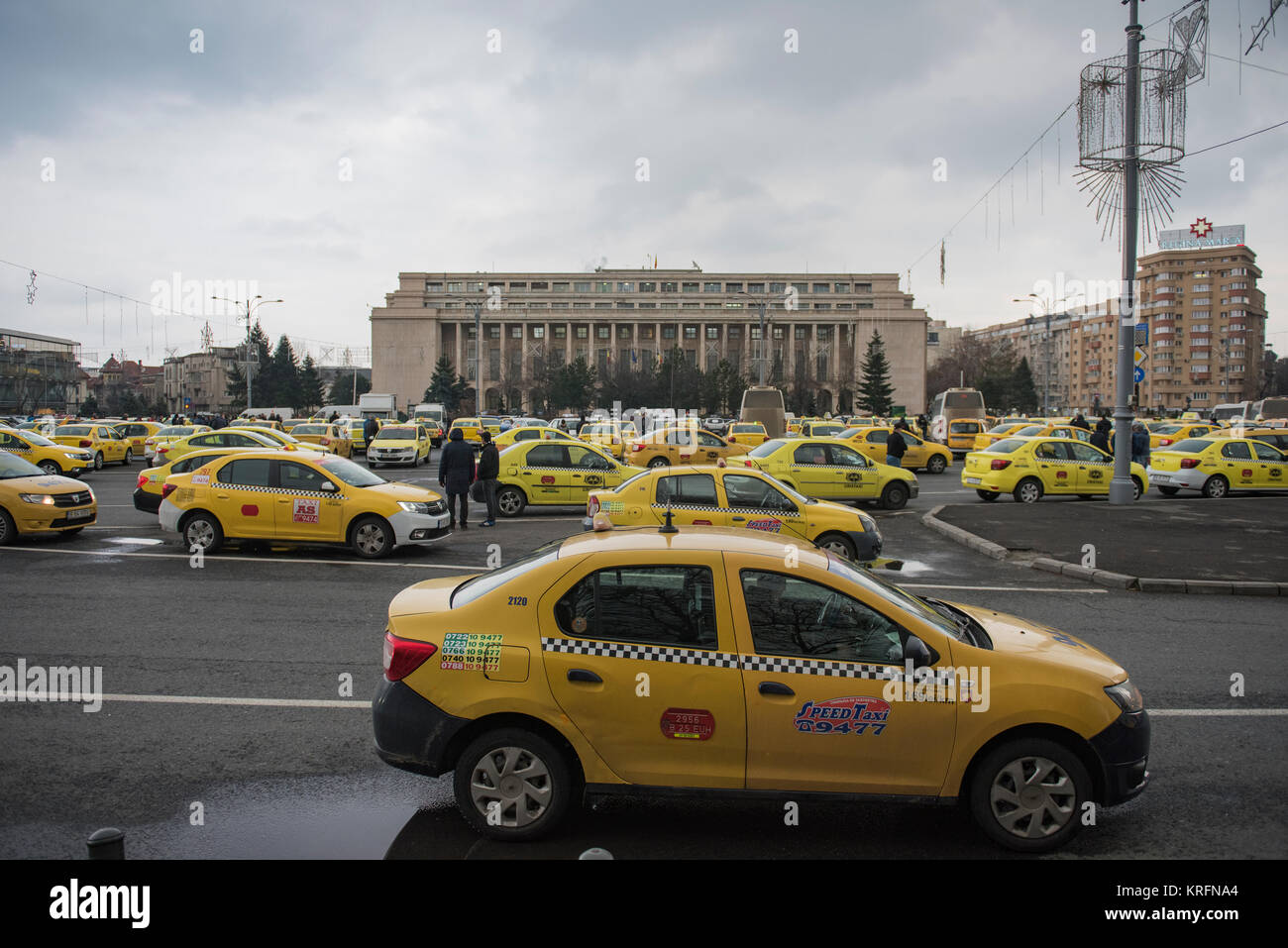 Bucharest, Romania - December 20, 2017: Romanian taxi drivers protest in front of the government headquarters against Uber and other apps that steal their clients. Stock Photo