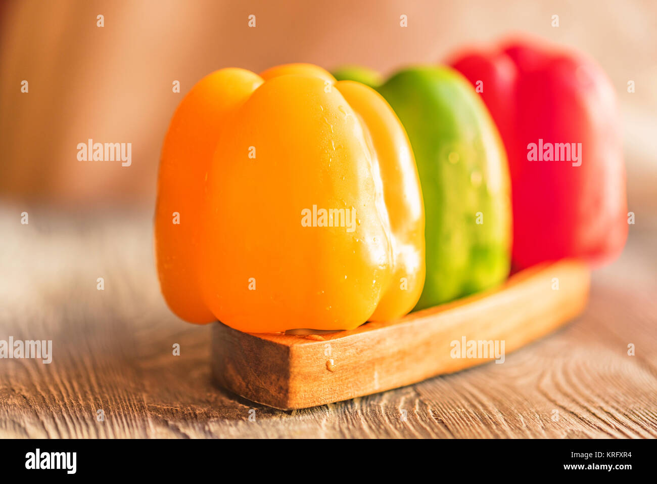 Variety of bell paprika peppers on cutting board Stock Photo - Alamy
