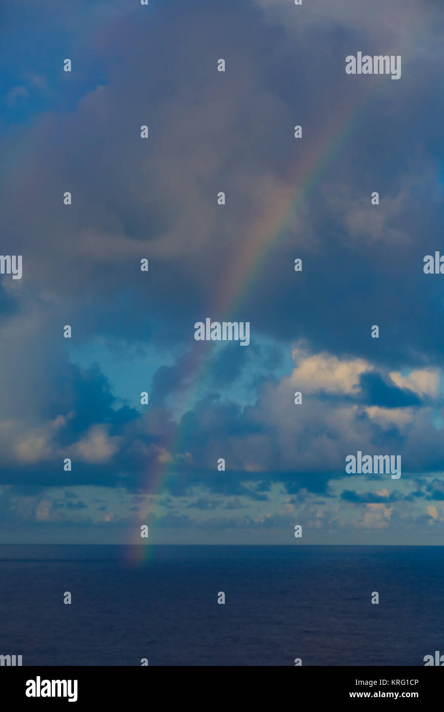 Colorful Rainbow over Ocean from Stormy Clouds Stock Photo - Alamy