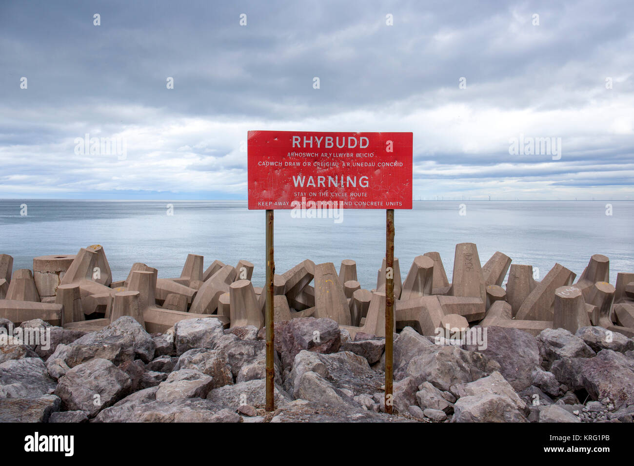 Danger warning sign Sea defence structure uneven surface. Do not climb