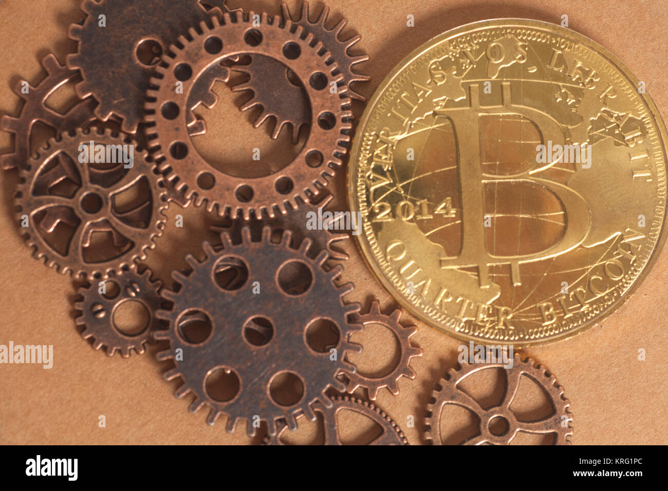 Metal gears wheels with bitcoin on a copper background Stock Photo - Alamy