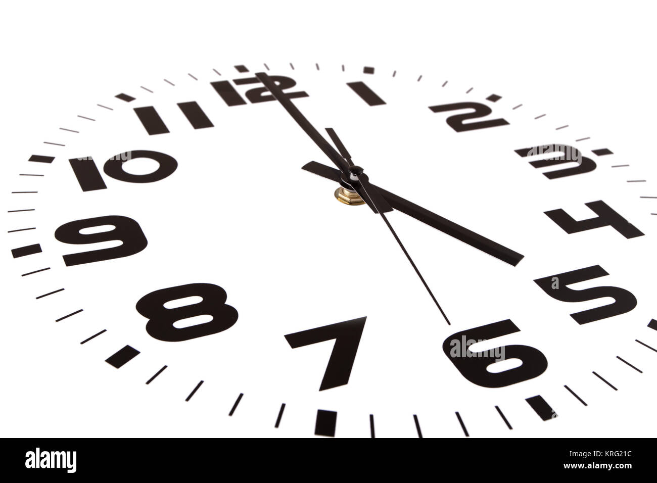 Clock isolated on white marking the five o'clock hour. The main focus