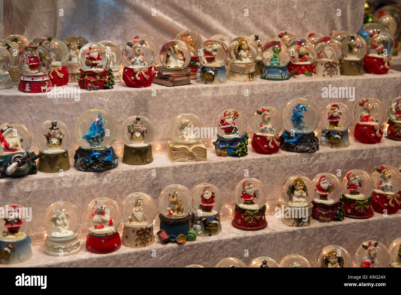 Christmas themed small snow globes are sold at a stall.
