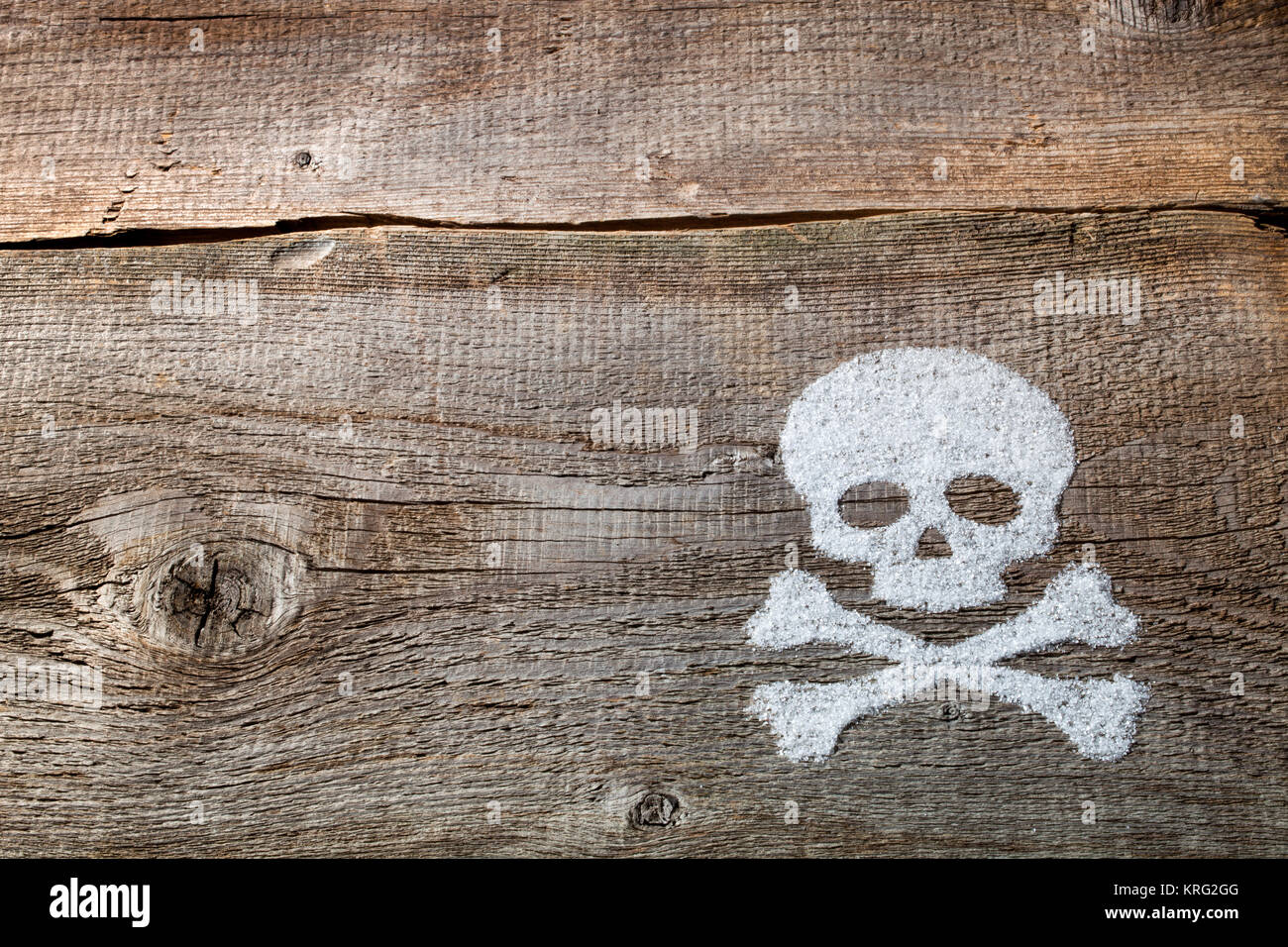 SKULL and two bones filled by flour in old wood table as background Stock Photo