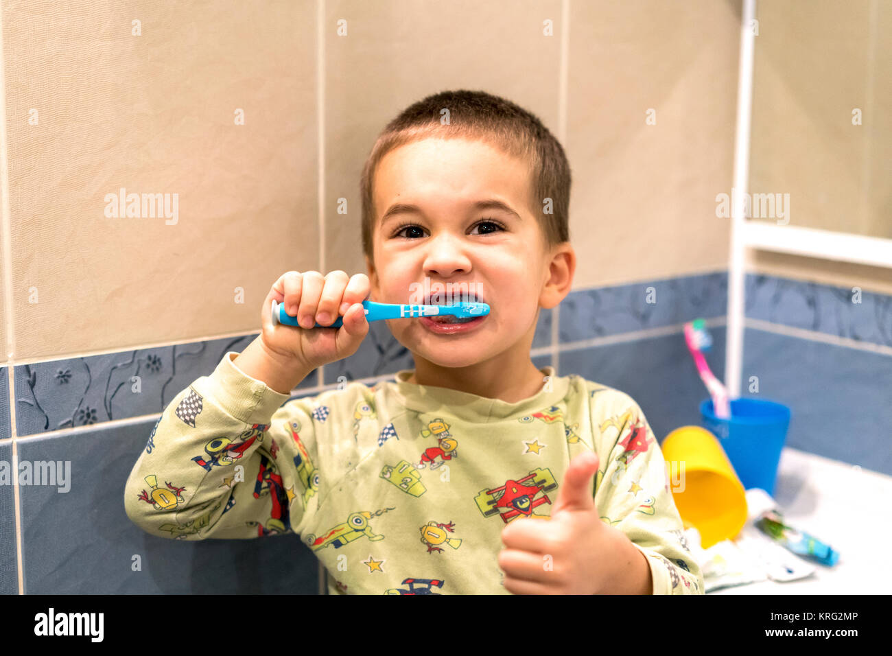 little boy brushes teeth in a bathroom Stock Photo Alamy