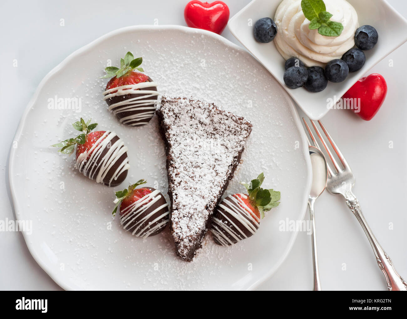 Chocolate cake slice with strawberries and blueberries on a plate Stock ...