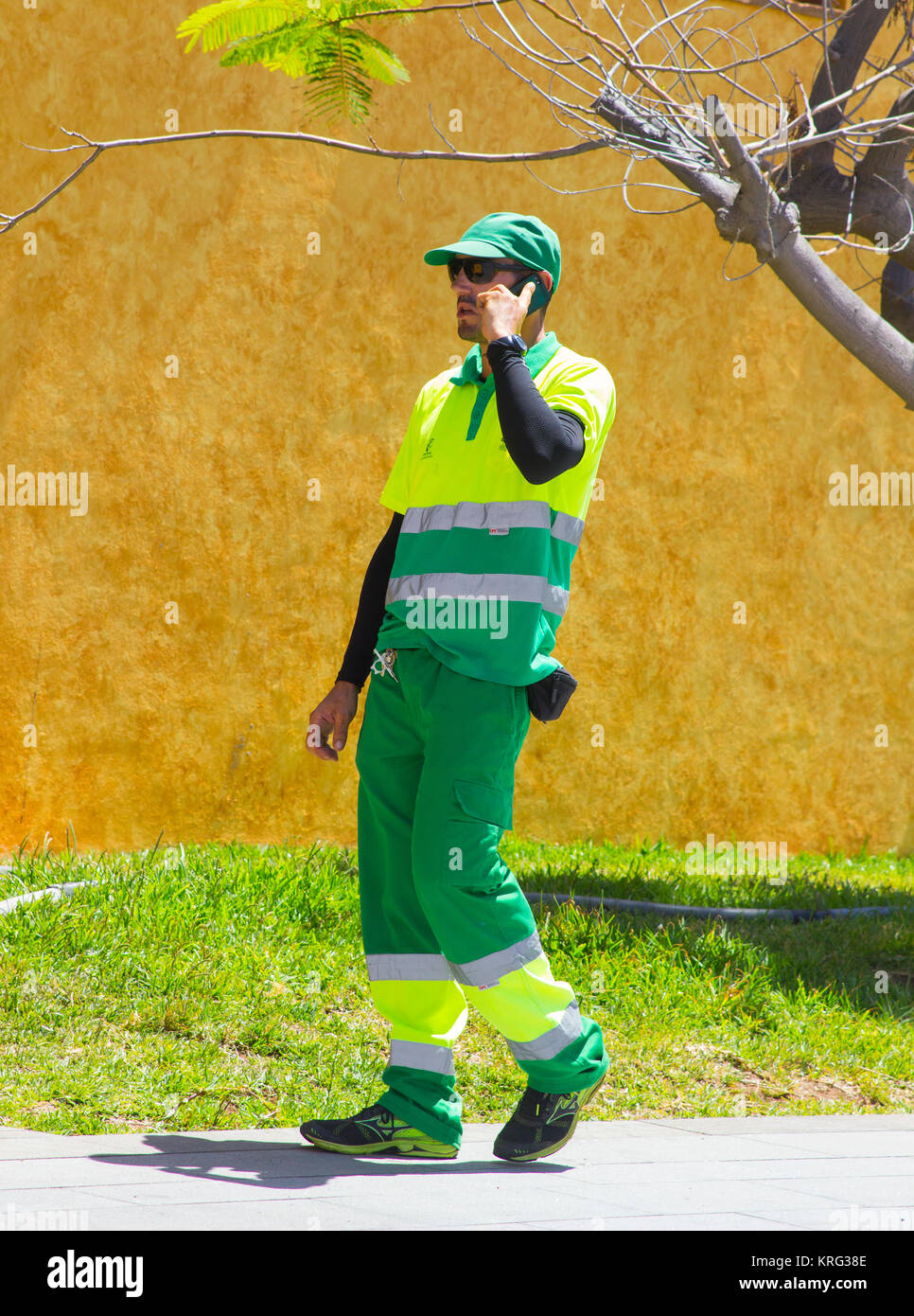 Los Cristianos Teneriffe A local environmental council worker on a mobile phone Stock Photo