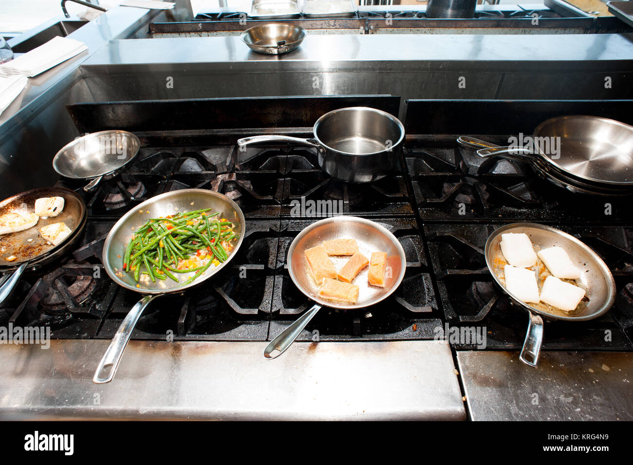 Cooktop with a range of sauté pans Stock Photo