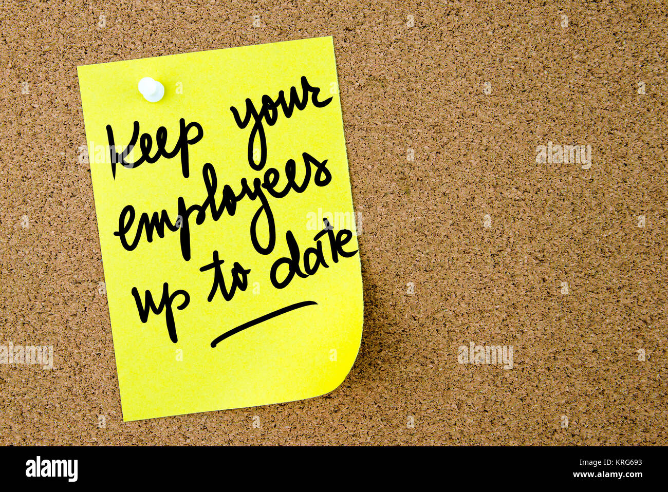 Keep Your Employees up to date text written on yellow paper note Stock Photo
